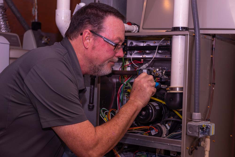 Farmington Valley technician servicing a furnace