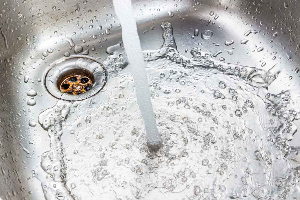 water flowing down the drain water flowing down the drain