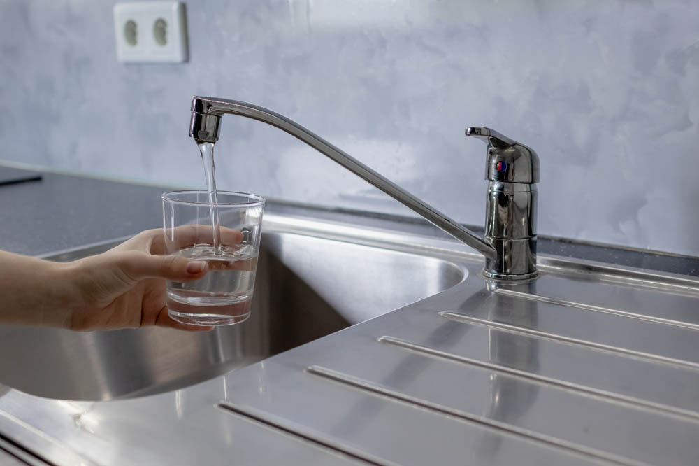 glass being filled with tap water
