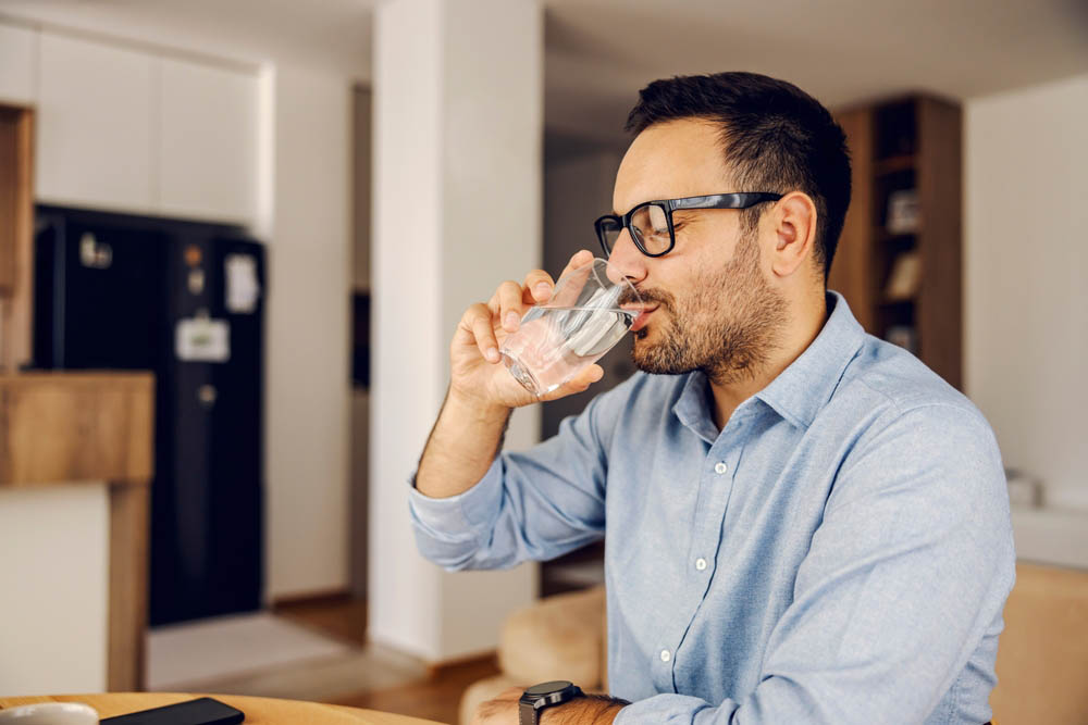 person drinking a glass of water person drinking a glass of water